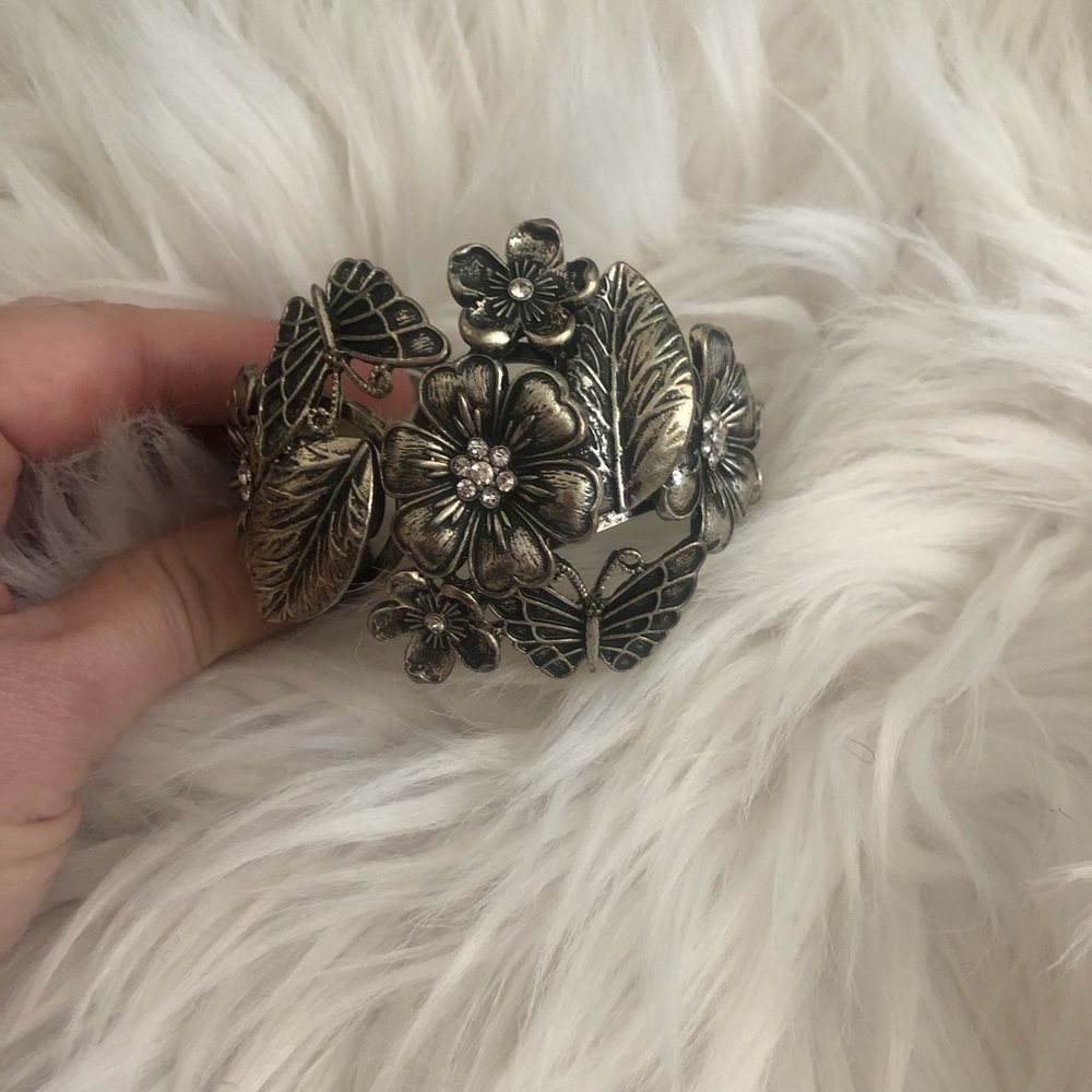 Silver butterfly and flower bracelet.